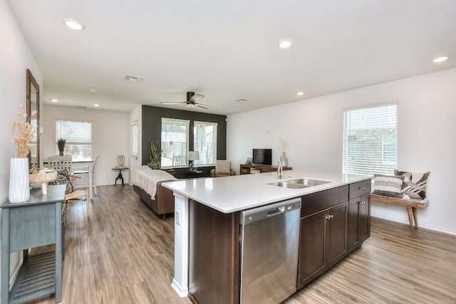 159 Andross Ln, Bastrop, TX 78602 - kitchen with dishwasher, a sink, open floor plan, light wood-style floors, and healthy amount of natural light