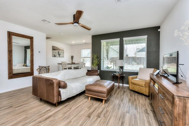 159 Andross Ln, Bastrop, TX 78602 - living area featuring light wood-style flooring, a ceiling fan, and baseboards