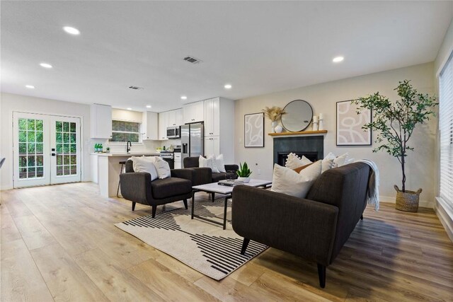 4507 Elana Ct, Austin, TX 78741 - living area featuring light wood-style flooring, recessed lighting, baseboards, and french doors