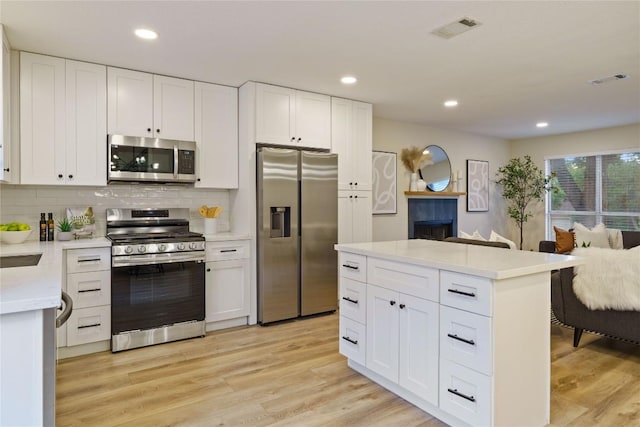 4507 Elana Ct, Austin, TX 78741 - kitchen featuring stainless steel appliances, open floor plan, backsplash, light countertops, and recessed lighting