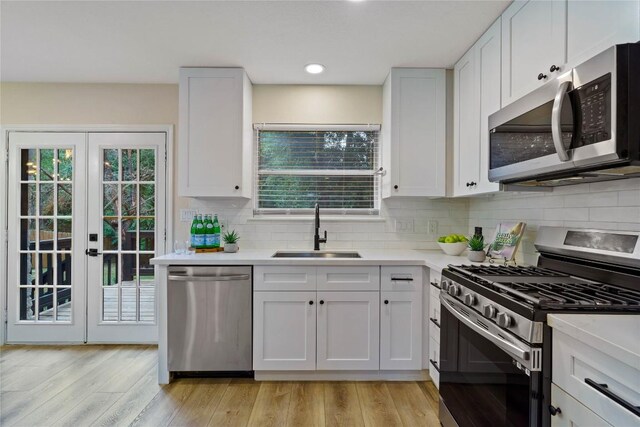 4507 Elana Ct, Austin, TX 78741 - kitchen featuring appliances with stainless steel finishes, a sink, light countertops, and recessed lighting