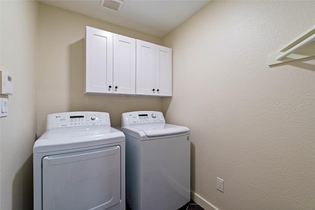 4507 Elana Ct, Austin, TX 78741 - laundry room featuring cabinet space and washing machine and clothes dryer
