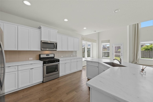 6724 Leonardo Dr, Round Rock, TX 78665 - kitchen featuring appliances with stainless steel finishes, a sink, white cabinetry, and recessed lighting