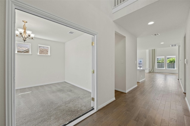 6724 Leonardo Dr, Round Rock, TX 78665 - hall with a chandelier, wood finished floors, baseboards, and recessed lighting