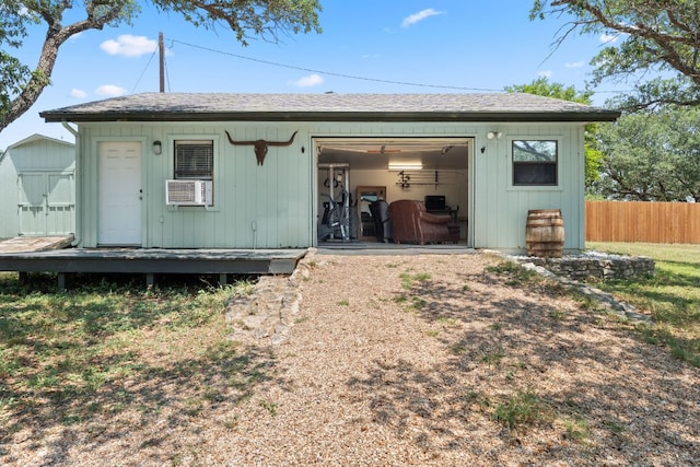 744 Jim Bowie Dr, Spicewood, TX 78669 - back of house with a garage, an outdoor structure, and cooling unit