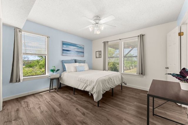 744 Jim Bowie Dr, Spicewood, TX 78669 - bedroom featuring a textured ceiling, wood finished floors, baseboards, and ceiling fan