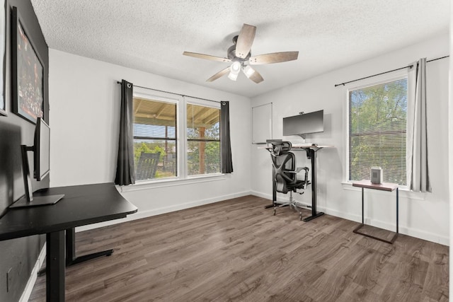 744 Jim Bowie Dr, Spicewood, TX 78669 - office with wood finished floors, a ceiling fan, a textured ceiling, and baseboards