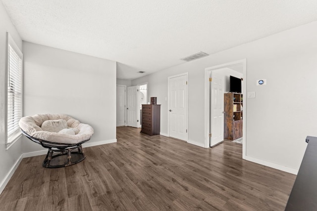 744 Jim Bowie Dr, Spicewood, TX 78669 - sitting room with dark wood-style floors and baseboards