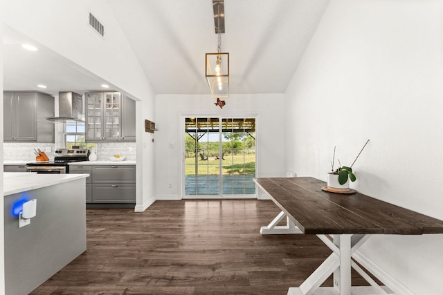 744 Jim Bowie Dr, Spicewood, TX 78669 - kitchen with gray cabinetry, electric range, wall chimney range hood, dark wood-type flooring, and vaulted ceiling