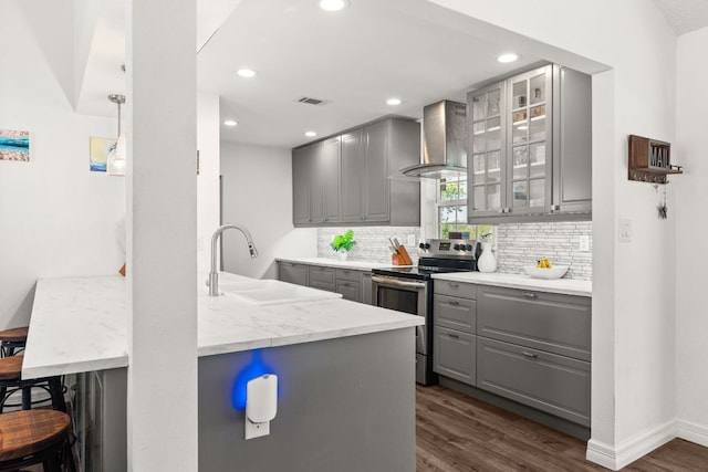 744 Jim Bowie Dr, Spicewood, TX 78669 - kitchen with gray cabinets, stainless steel electric range oven, wall chimney exhaust hood, a sink, and dark wood-style flooring