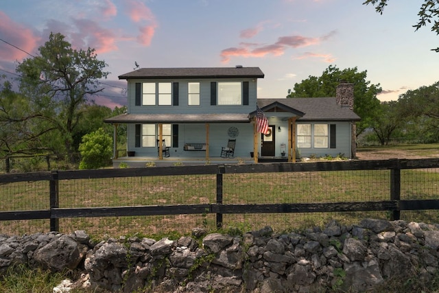 744 Jim Bowie Dr, Spicewood, TX 78669 - view of front facade with a porch and a chimney