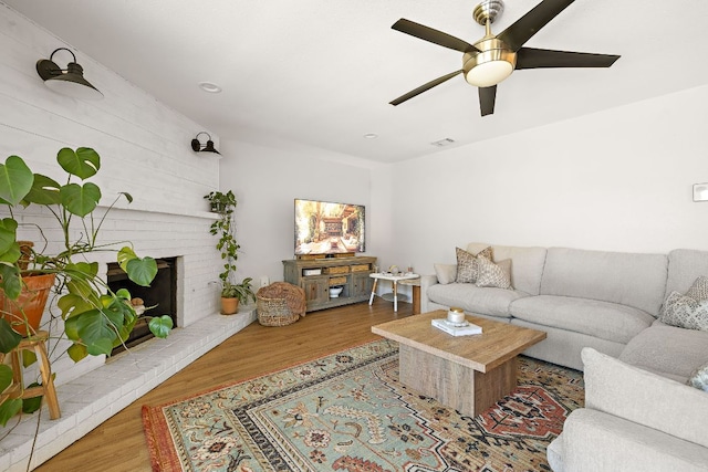 11200 Bending Bough Trl, Austin, TX 78758 - living room featuring a ceiling fan, wood finished floors, a brick fireplace, and recessed lighting