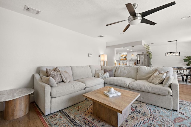 11200 Bending Bough Trl, Austin, TX 78758 - living area with wood finished floors, ceiling fan, and recessed lighting