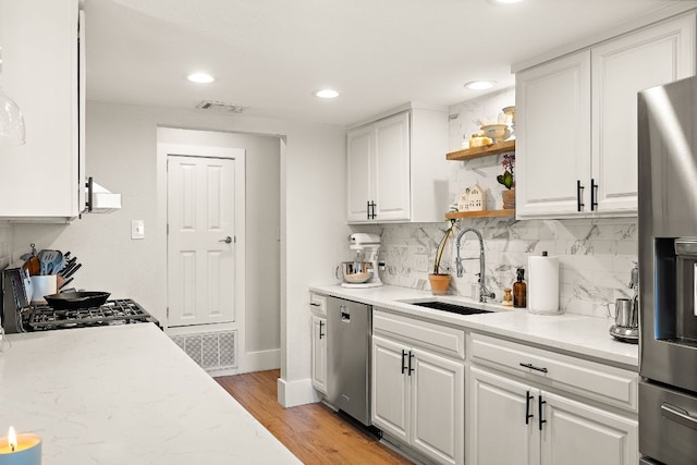 11200 Bending Bough Trl, Austin, TX 78758 - kitchen featuring appliances with stainless steel finishes, a sink, open shelves, white cabinets, and recessed lighting