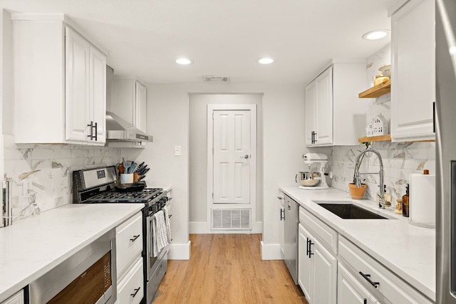 11200 Bending Bough Trl, Austin, TX 78758 - kitchen with appliances with stainless steel finishes, a sink, open shelves, under cabinet range hood, and white cabinets