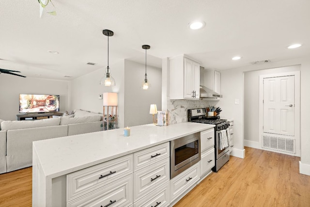 11200 Bending Bough Trl, Austin, TX 78758 - kitchen featuring stainless steel appliances, ventilation hood, white cabinets, light wood finished floors, and recessed lighting
