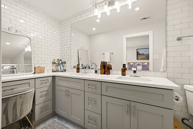 11200 Bending Bough Trl, Austin, TX 78758 - full bathroom with tile walls, double vanity, a tile shower, and recessed lighting