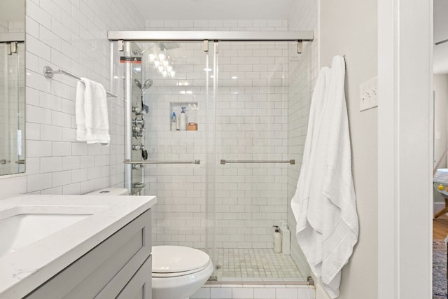 11200 Bending Bough Trl, Austin, TX 78758 - bathroom featuring vanity, toilet, a shower stall, and tile walls