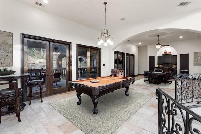 604 Logans Ln, Austin, TX 78746 - recreation room featuring french doors, arched walkways, stone tile flooring, a ceiling fan, and recessed lighting