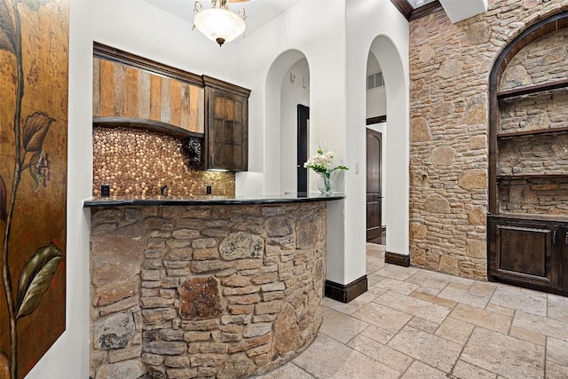 604 Logans Ln, Austin, TX 78746 - indoor wet bar with stone tile floors and arched walkways