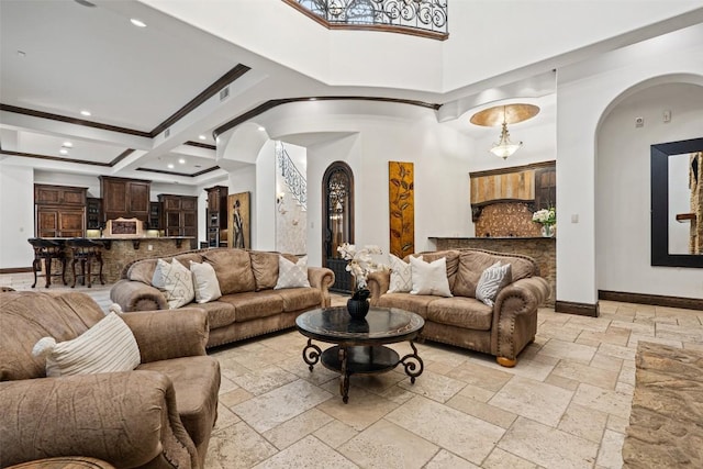 604 Logans Ln, Austin, TX 78746 - living area with arched walkways, stone tile flooring, recessed lighting, beamed ceiling, and a high ceiling