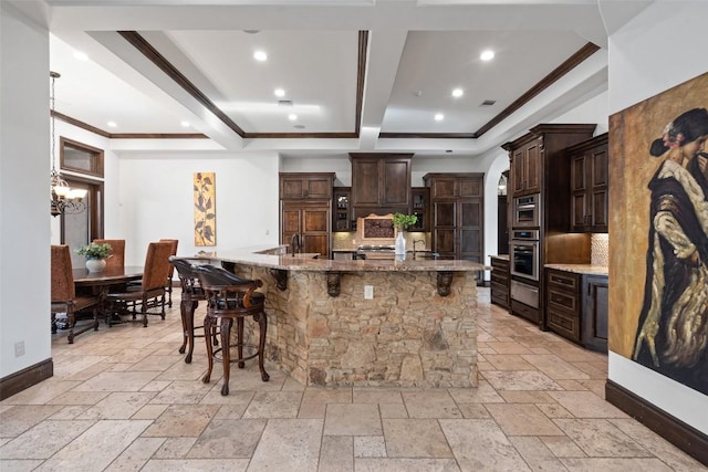 604 Logans Ln, Austin, TX 78746 - kitchen with stainless steel oven, decorative backsplash, stone tile flooring, a breakfast bar area, and recessed lighting