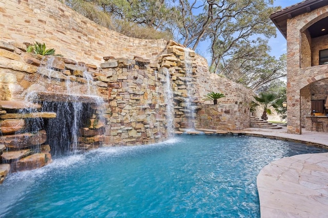604 Logans Ln, Austin, TX 78746 - swimming pool featuring a fireplace and a patio