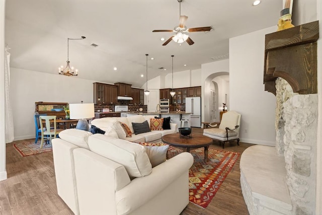 310 Lauren Trl, Cedar Park, TX 78613 - living room with arched walkways, ceiling fan, baseboards, wood finished floors, and lofted ceiling