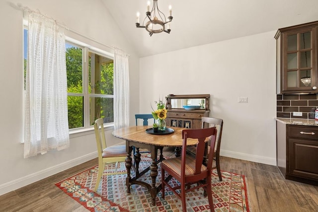 310 Lauren Trl, Cedar Park, TX 78613 - dining area featuring a chandelier, baseboards, dark wood-style floors, and vaulted ceiling