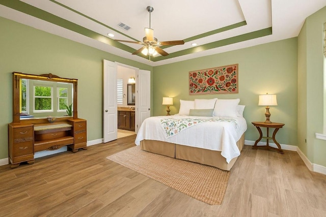 310 Lauren Trl, Cedar Park, TX 78613 - bedroom with baseboards, wood finished floors, a tray ceiling, and recessed lighting
