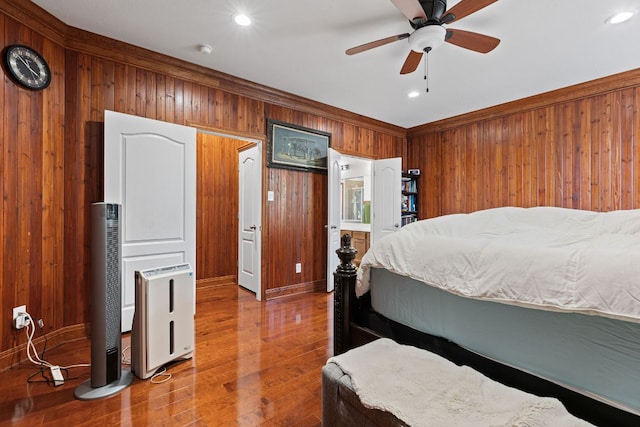 113 Blossom Valley Strm, Buda, TX 78610 - bedroom featuring wooden walls, wood finished floors, recessed lighting, ornamental molding, and a ceiling fan