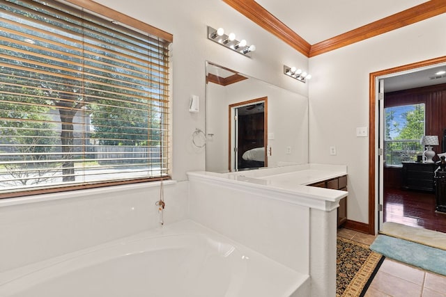 113 Blossom Valley Strm, Buda, TX 78610 - ensuite bathroom featuring crown molding, a garden tub, tile patterned floors, and vanity
