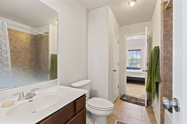 113 Blossom Valley Strm, Buda, TX 78610 - ensuite bathroom with vanity, tile patterned floors, a shower with shower curtain, and toilet
