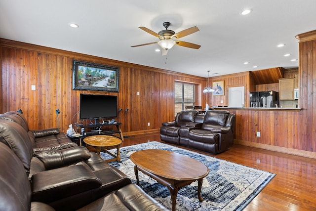 113 Blossom Valley Strm, Buda, TX 78610 - living area featuring wood walls, a ceiling fan, baseboards, wood finished floors, and recessed lighting