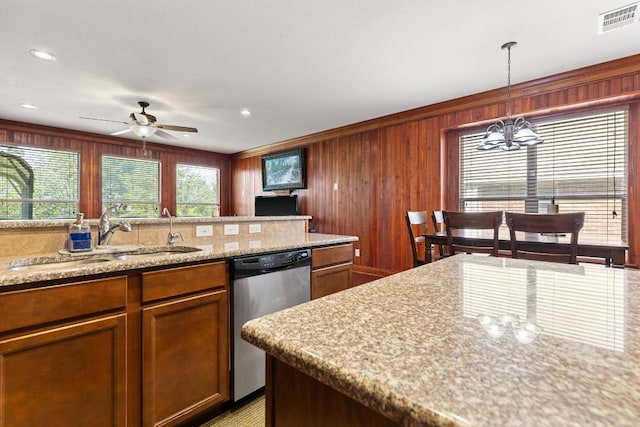 113 Blossom Valley Strm, Buda, TX 78610 - kitchen with dishwasher, a sink, a chandelier, ceiling fan, and wooden walls