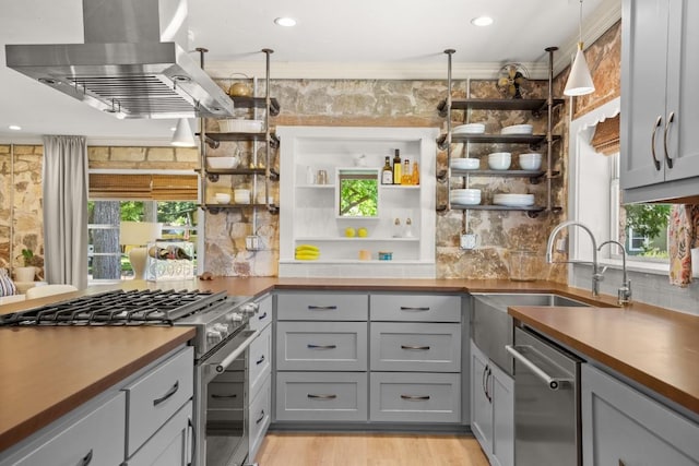 1507 Ash St, Georgetown, TX 78626 - kitchen featuring ventilation hood, appliances with stainless steel finishes, gray cabinets, open shelves, and decorative backsplash