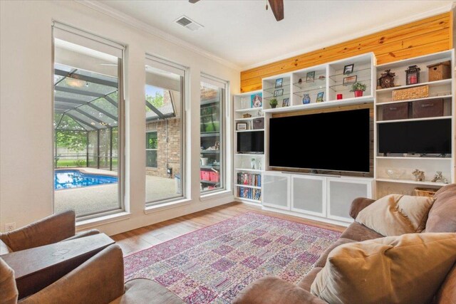 119 Tallwood Cir, Salado, TX 76571 - living area featuring crown molding, a ceiling fan, wood finished floors, and a sunroom