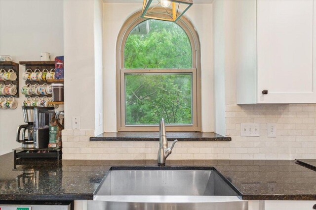 119 Tallwood Cir, Salado, TX 76571 - kitchen with a sink, white cabinetry, dark stone counters, and decorative backsplash
