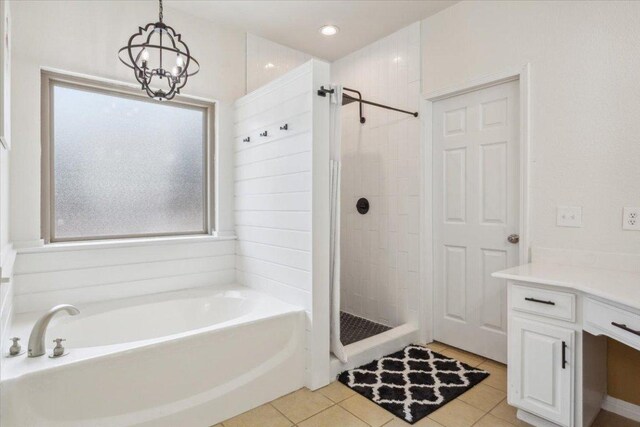 119 Tallwood Cir, Salado, TX 76571 - bathroom featuring a garden tub, a stall shower, vanity, tile patterned floors, and a chandelier