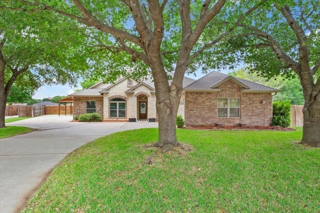 119 Tallwood Cir, Salado, TX 76571 - view of front facade with driveway, brick siding, and a shingled roof