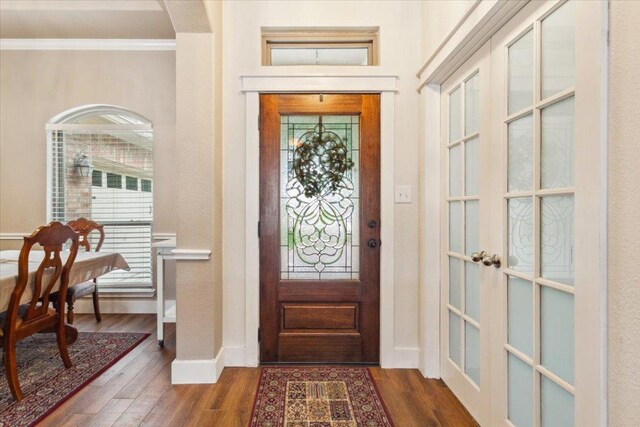 119 Tallwood Cir, Salado, TX 76571 - foyer entrance featuring ornamental molding, french doors, wood finished floors, baseboards, and arched walkways