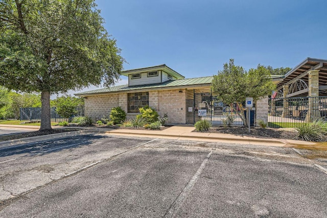 7701 Crackling Creek Dr, Austin, TX 78736 - view of front facade with uncovered parking and metal roof