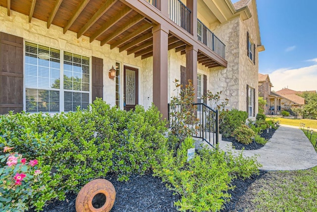 7701 Crackling Creek Dr, Austin, TX 78736 - property entrance featuring stone siding, a balcony, and stucco siding