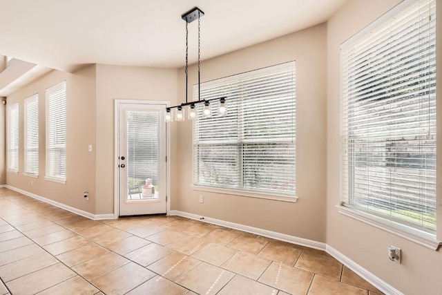 7701 Crackling Creek Dr, Austin, TX 78736 - unfurnished dining area with light tile patterned flooring and healthy amount of natural light