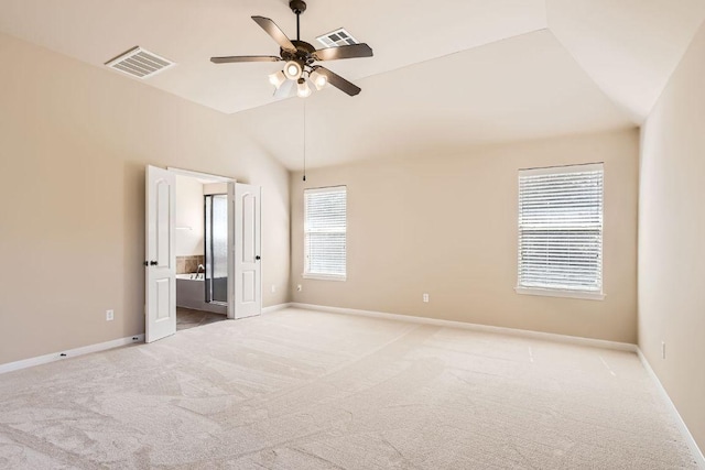 7701 Crackling Creek Dr, Austin, TX 78736 - unfurnished bedroom with vaulted ceiling, carpet floors, baseboards, ensuite bath, and ceiling fan