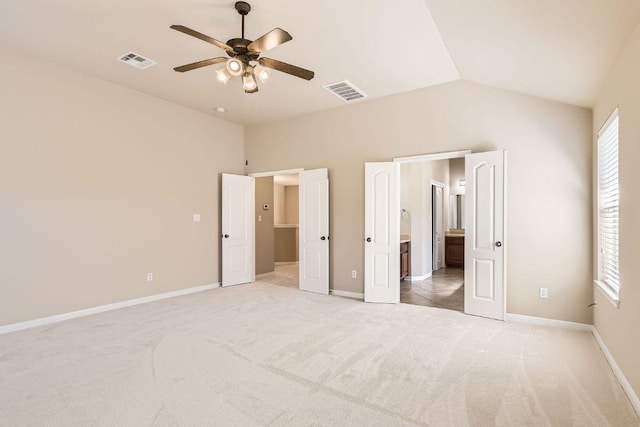 7701 Crackling Creek Dr, Austin, TX 78736 - unfurnished bedroom featuring light carpet, lofted ceiling, baseboards, ensuite bath, and ceiling fan