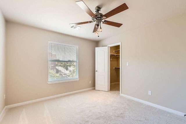 7701 Crackling Creek Dr, Austin, TX 78736 - unfurnished bedroom featuring a spacious closet, light carpet, and a ceiling fan