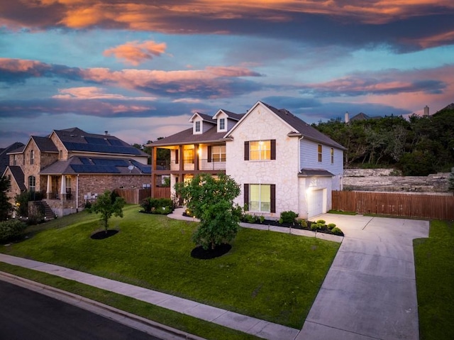 7701 Crackling Creek Dr, Austin, TX 78736 - view of front of house featuring a garage, driveway, stone siding, and a balcony