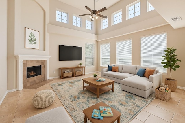 7701 Crackling Creek Dr, Austin, TX 78736 - tiled living area featuring a ceiling fan, a fireplace, and a towering ceiling