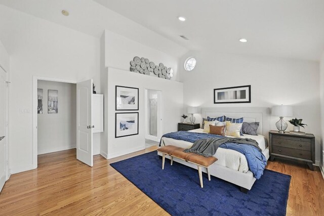 905 Juanita St, Austin, TX 78704 - bedroom with high vaulted ceiling, light wood finished floors, and baseboards